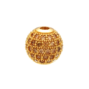 Macro shot of a golden spherical bead paved with brown micro-set cubic zirconia crystals