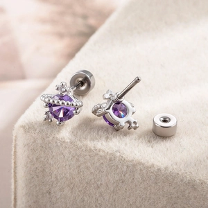 Star-shaped purple zircon stud earrings in stainless steel with a planet design
