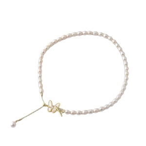 Elegant freshwater pearl necklace featuring a gold butterfly zircon clasp and tassel pendant
