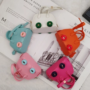 Flat lay of colorful mini shell bags with lychee pattern PU leather and dual handles