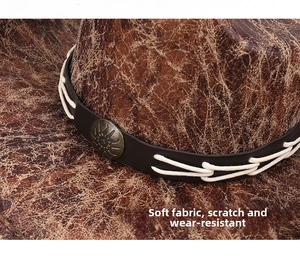 Detail of faux leather cowboy hat featuring vintage crackle texture and metal star buckle