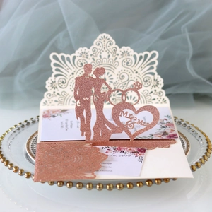 Macro view of rose gold laser cut wedding invitation with glitter finish and Mr & Mrs design
