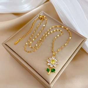 Elegant gold titanium daisy necklace with crystals on silk champagne jewelry box