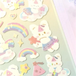 Detail view of cute holographic bear and rainbow stickers with soft pastel colors