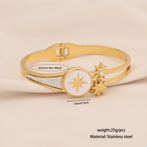 Gold stainless steel starburst bangle with white enamel detail and star charms