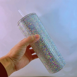 Close-up of a holographic rhinestone straw cup with sparkling crystals and rainbow reflections