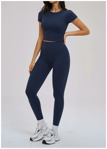 Detail of navy blue women yoga set with high waist leggings and short sleeve crop top