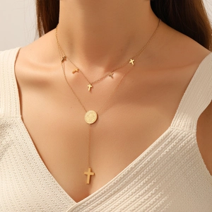 Double layer stainless steel necklace with cross pendants and round coin on a fashion model