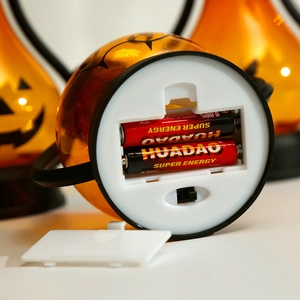 Bottom view of Halloween pumpkin lantern showing battery compartment and on-off switch