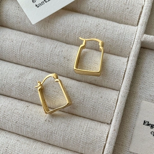 Detail of S925 sterling silver geometric rectangular hoop earrings in gold finish
