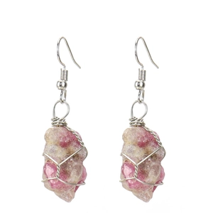 Detail of handmade silver wire wrapped raw pink tourmaline stone drop earrings for women