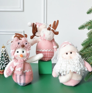 Pink Christmas plush ornaments featuring Santa, reindeer, and snowman figurines