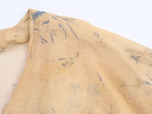 Close-up of floral print fabric with V-neck stitching on champagne slim-fit top
