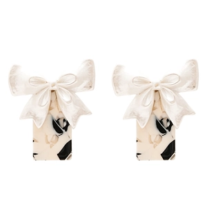 Vintage bow earrings with black and white marble resin pendant on white background