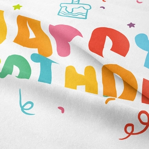 Detail of colorful Happy Birthday print on soft white bohemian fabric tapestry
