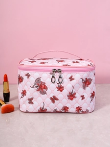 Macro view of pink quilted cosmetic bag with red butterfly print and double zippers