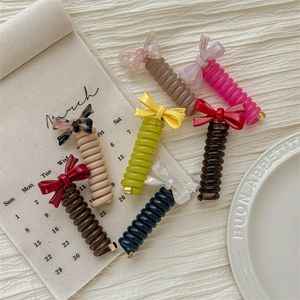 Colorful spiral hair ties with assorted bow details in matte and leopard print finishes