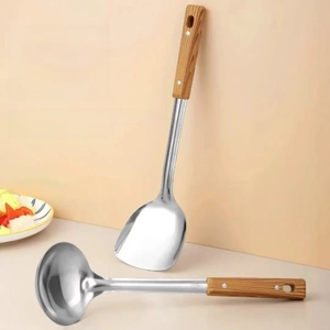 Detail view of stainless steel spatula and ladle set with ergonomic wood handles
