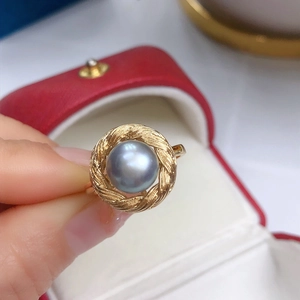Vintage gold woven ring featuring a round grey pearl centerpiece in a gift box