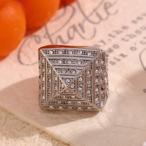 Macro detail of silver layered square ring paved with white sparkling zircon stones