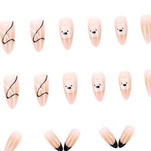 French almond press-on nails featuring cream puppy designs and gradient black line art