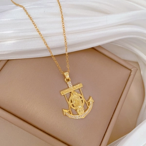 Luxurious gold anchor pendant necklace with Virgin Mary motif and sparkling crystals