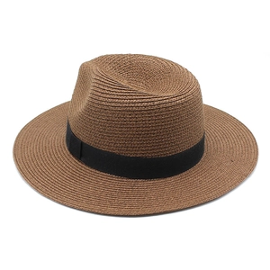 Close-up of tight spiral weave texture and black satin ribbon on tan straw fedora