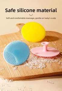 Detailed macro view of soft silicone baby head brushes in yellow, blue and pink colors