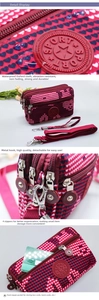 Detail view of red heart crossbody bag with four zipper pockets and metal hooks