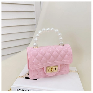 Detail of pink quilted jelly bag with pearl handle, gold twist lock and chain strap