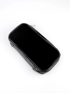 Macro shot of large black glossy PU leather makeup brush bag with dual silver metal zippers