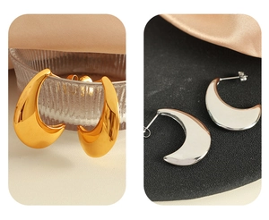 Detailed comparison of minimalist gold and silver crescent drop earrings with smooth texture