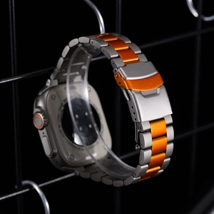 Detail of gray and orange titanium alloy watch band with professional folding clasp