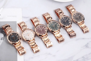 Flat lay of Tadi rose gold watches with Roman numerals and various dial colors