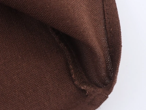 Detailed macro view of the brown knit fabric texture and high-quality edge stitching
