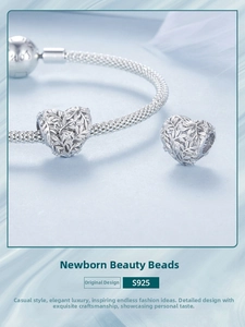 Macro shot of S925 sterling silver heart charm with vine patterns and S925 hallmark
