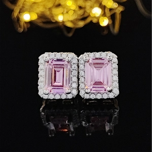 Pink emerald cut gemstone stud earrings with a sparkling white diamond halo