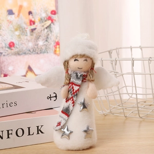 Detailed view of a plush white angel doll with yarn hat and star dress on a wooden table