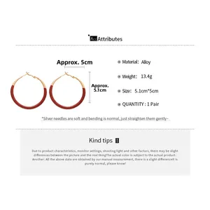 Detail view of large red and gold alloy hoop earrings showing 5.1cm size and 13.4g weight