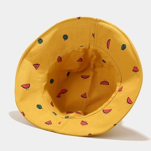 Detail of yellow cotton bucket hat featuring cute cartoon watermelon embroidery and sun brim