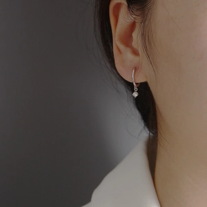 Elegant s925 silver hoop earrings with white pearl pendant shown on a model