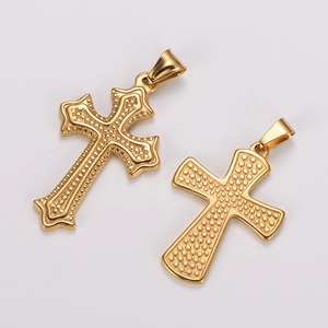 Close-up of golden stainless steel cross pendants with embossed dot texture and bail charm