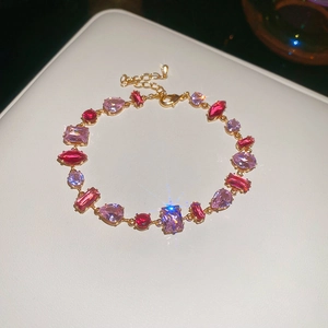 Detailed macro view of colorful zircon crystals set in a gold-plated adjustable bracelet