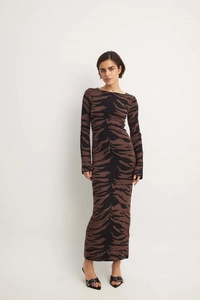 Detailed close-up of tiger print pattern on elegant long-sleeved slim fit knit maxi dress