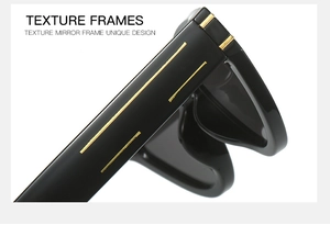 Macro view of black polished temples with parallel golden metal stripes on cat eye sunglasses