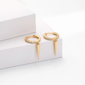 Detailed macro view of S925 sterling silver huggie earrings with gold spikes and pave crystals