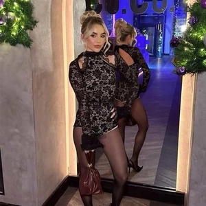 Detailed mirror view of back cutout and lace stitching on black high neck bodysuit