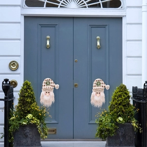 Symmetric placement of Santa door handle covers with beige plaid hats on a blue double door
