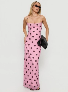 Macro detail of pink fabric with black polka dots and fine spaghetti strap design