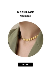 Macro view of French style brushed matte gold circle plate choker necklace on neck